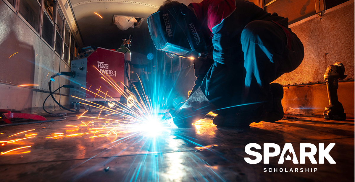 Welder fixing a garage floor. Tradez Spark Scholarship logo